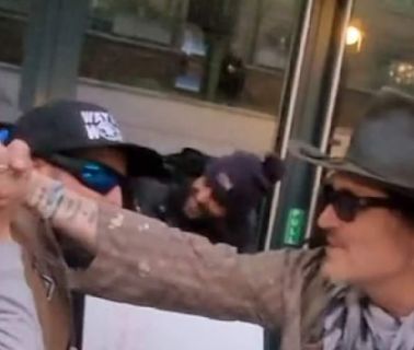 Johnny Depp is mobbed by fans in London and kisses one on the hand
