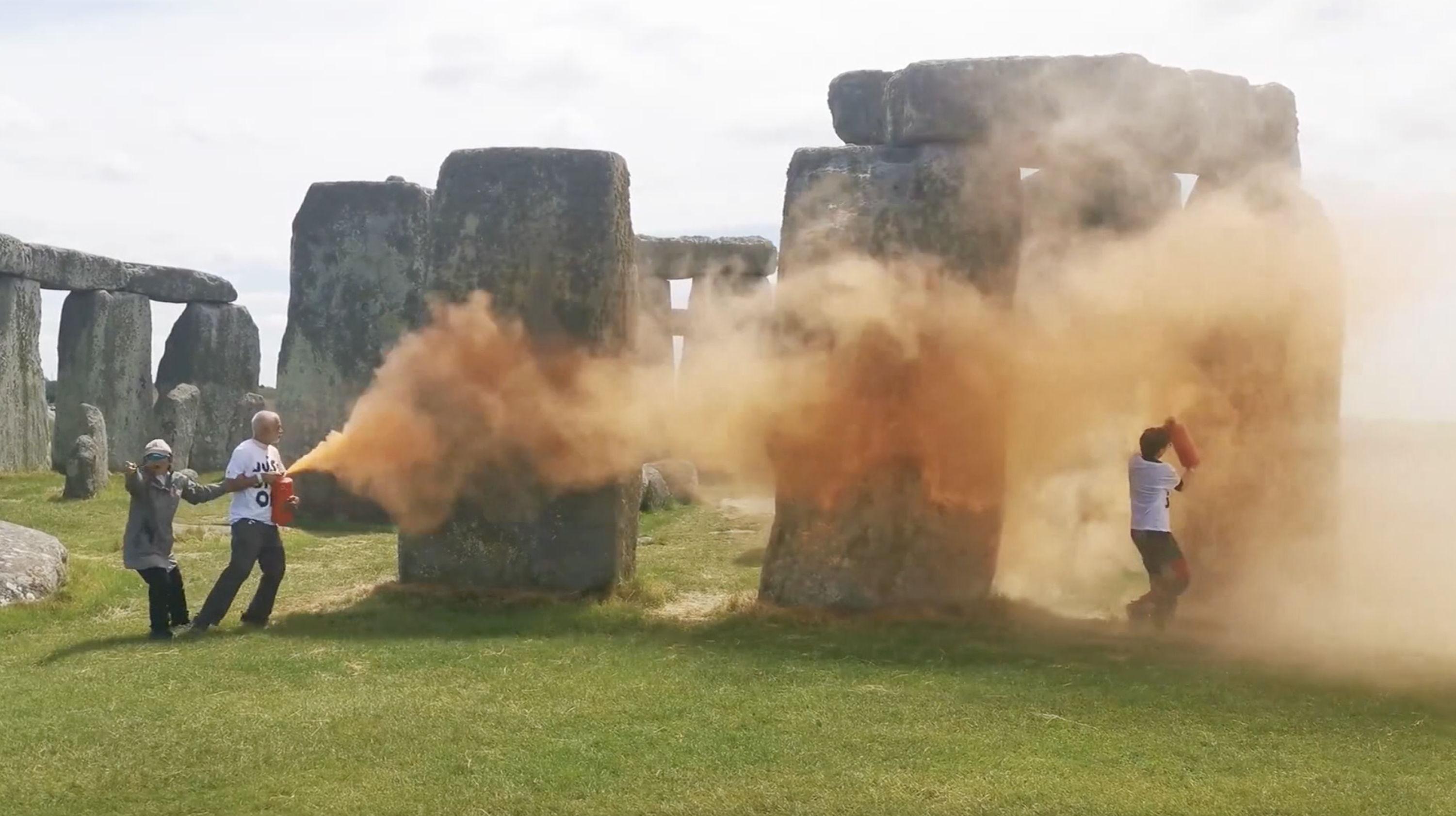 Climate activists spray England's ancient Stonehenge monument with orange paint