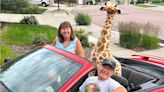 Couple Brings ‘So Much Joy’ by Driving a Stuffed Giraffe Around in Their Convertible