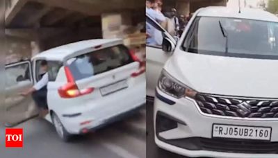 Viral video: Traffic cop risks own life to catch taxi driver trying to flee | Faridabad News - Times of India