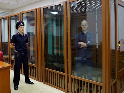 Evan Gershkovich appears in glass cage as espionage trial begins in Russia