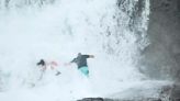 Watch: Father, daughter nearly swept to sea in pounding surf