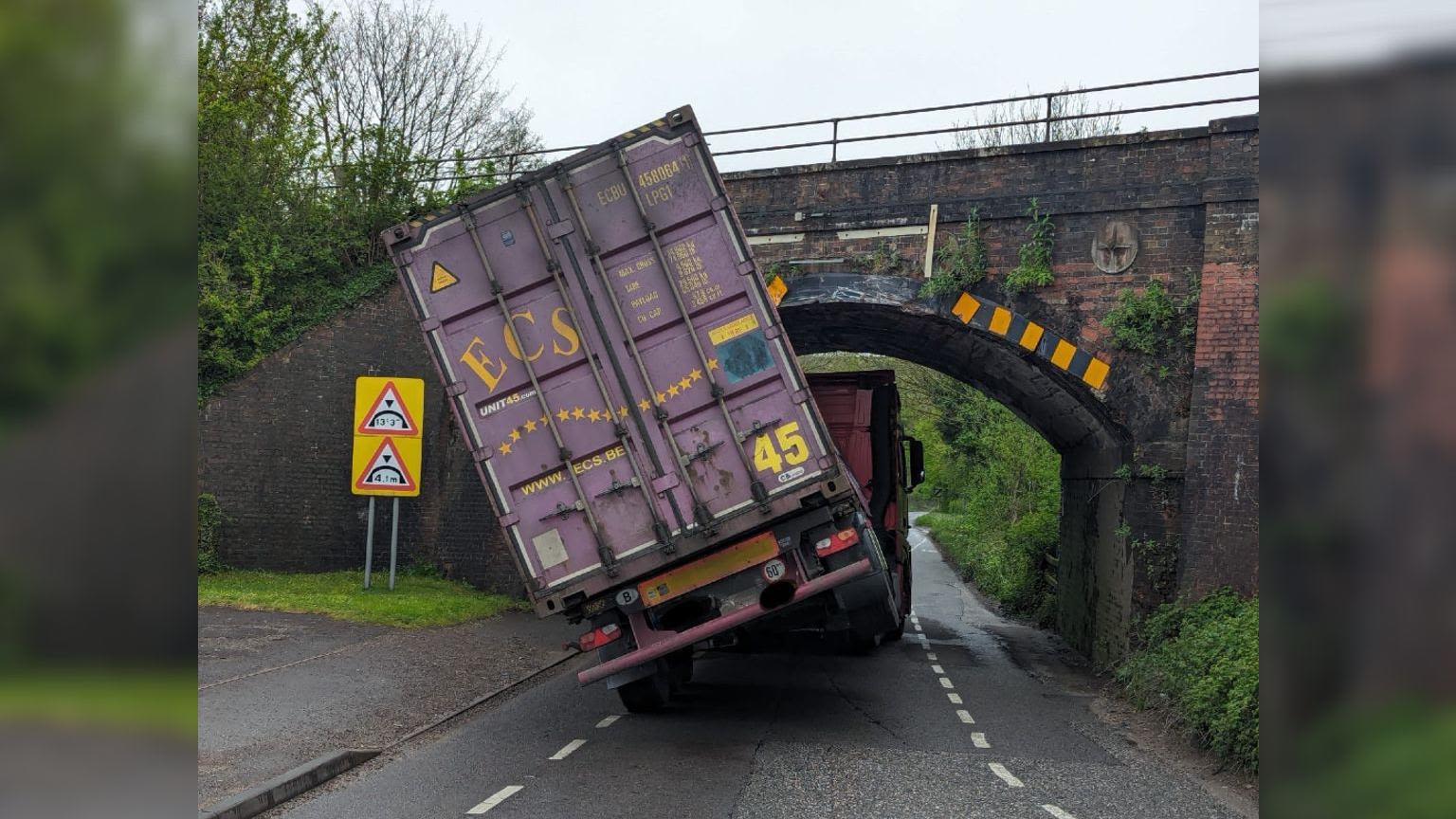 HGV lorry lodged underneath bridge following crash