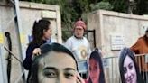 Relatives and supporters set up cardboard cutout portraits of Israeli women held hostage in Gaza outside Prime Minister Benjamin Netanyahu's Jerusalem residence