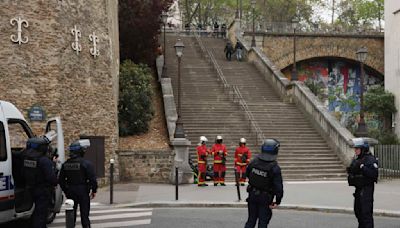 Police in Paris detain a man wearing fake explosives vest at Iran's Consulate