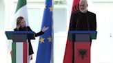 Italy’s premier visits Albania as controversial plan to hold Italy-bound migrants nears its start