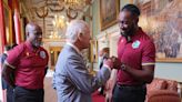 Charles learns fist-bump from players on the West Indian cricket team