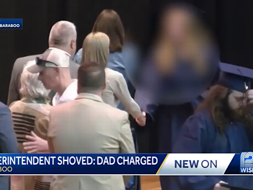Dad pushes superintendent away from graduating daughter, video shows. He’s charged