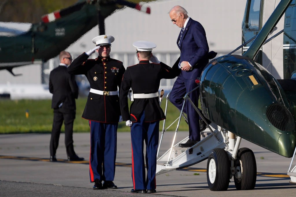 Biden, 81, has aides flank him on walks to Marine One to block cameras from catching him shuffling, stumbling: report