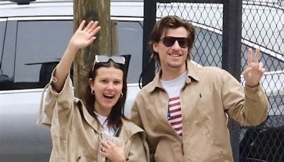 Millie Bobby Brown, 20, and fiance Jake Bongiovi, 21, match in tan shirts as they enthusiastically wave during NYC stroll