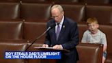 Congressman's son pulls funny faces behind dad during House floor speech | WATCH