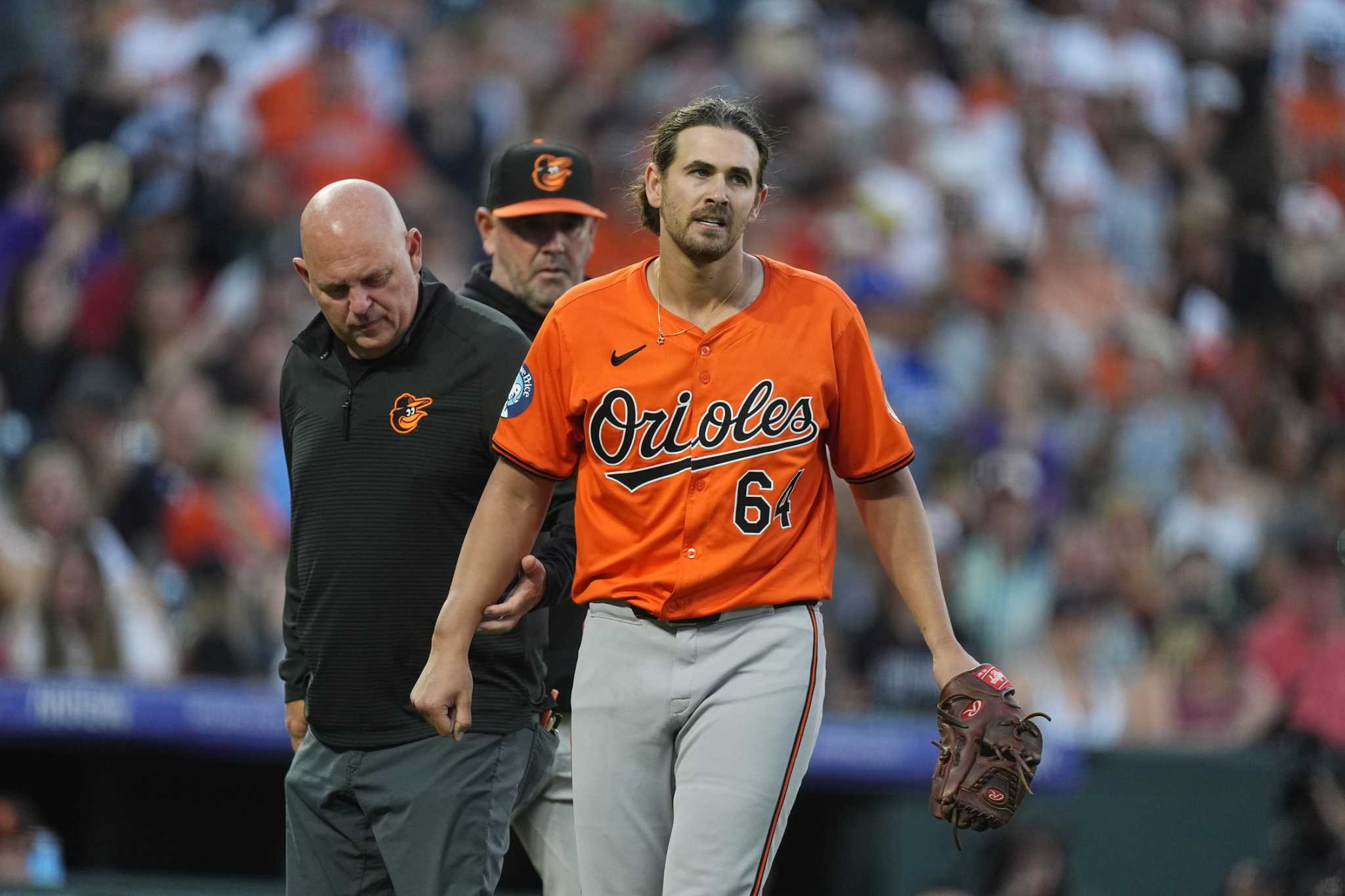 Orioles pitcher Dean Kremer departs after he gets hit on his right forearm by a line drive