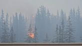 Huge wildfire burns down part of western Canadian town, rain forecast