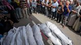An airstrike kills 20 in central Gaza as Israel's leaders air wartime divisions