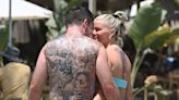 Loved-up Kerry Katona grabs fiance Ryan's bum on the beach as she strips off