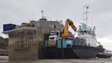 ‘Toxic’ barge that sank more than a year ago is still beached in a scenic bay