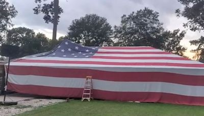 Father and son drape entire house with American flag for July 4th