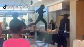 California Chipotle breaks into food fight; Woman stands on table, counter during kitchen chaos