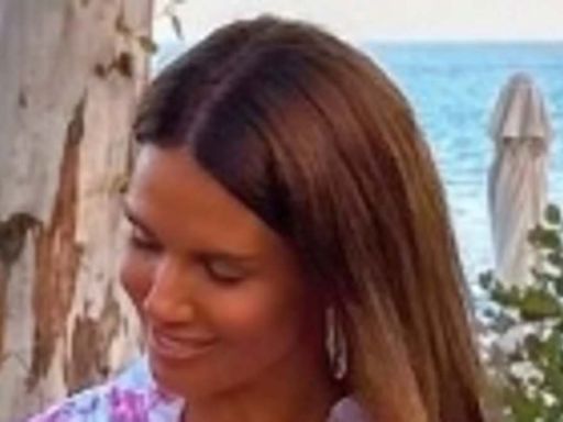 Rebekah Vardy gives cheeky flash of her bottom in a black thong bikini