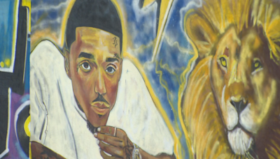 Loved ones honor slain Baltimore rapper "President Davo" with mural, vegetable garden