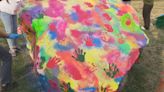 Virginia students decorate Thomas Jefferson High School Rock to mark Holi festival