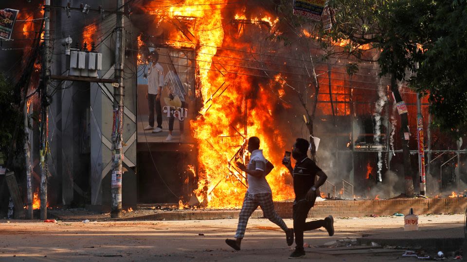 Bangladesh prime minister flees to India as anti-government protesters storm her residence