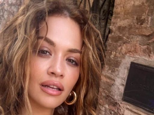 Rita Ora shows she poses in a tiny bikini while on a trip to Italy