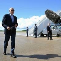 US President Joe Biden walks to speak with the press before boarding Air Force One prior to departure from Dane County Regional Airport in Madison