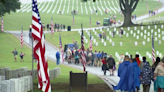 Local Boy Scouts plant thousands of flags at headstones for Memorial Day Weekend