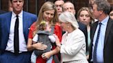 Baby-wearing Carrie Johnson stands out in red dress during Boris' resignation speech