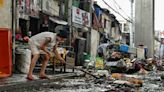 ‘Back to zero’: Manila flood victims clean up, start again