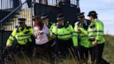 Environmental activists briefly disrupt British Open by dumping orange powder beside 17th green