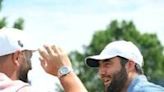 Spain's Jon Rahm, left, and American Scottie Scheffler, right, talk during a practice round as the two-time major winners prepare for the 106th PGA Championship