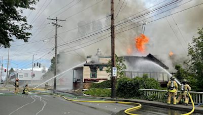 Flames shoot high into the sky as an abandoned restaurant burns in Tumwater