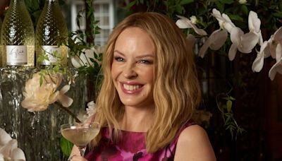 Kylie Minogue looks better than ever in bow-adorned satin dress as she turns 56