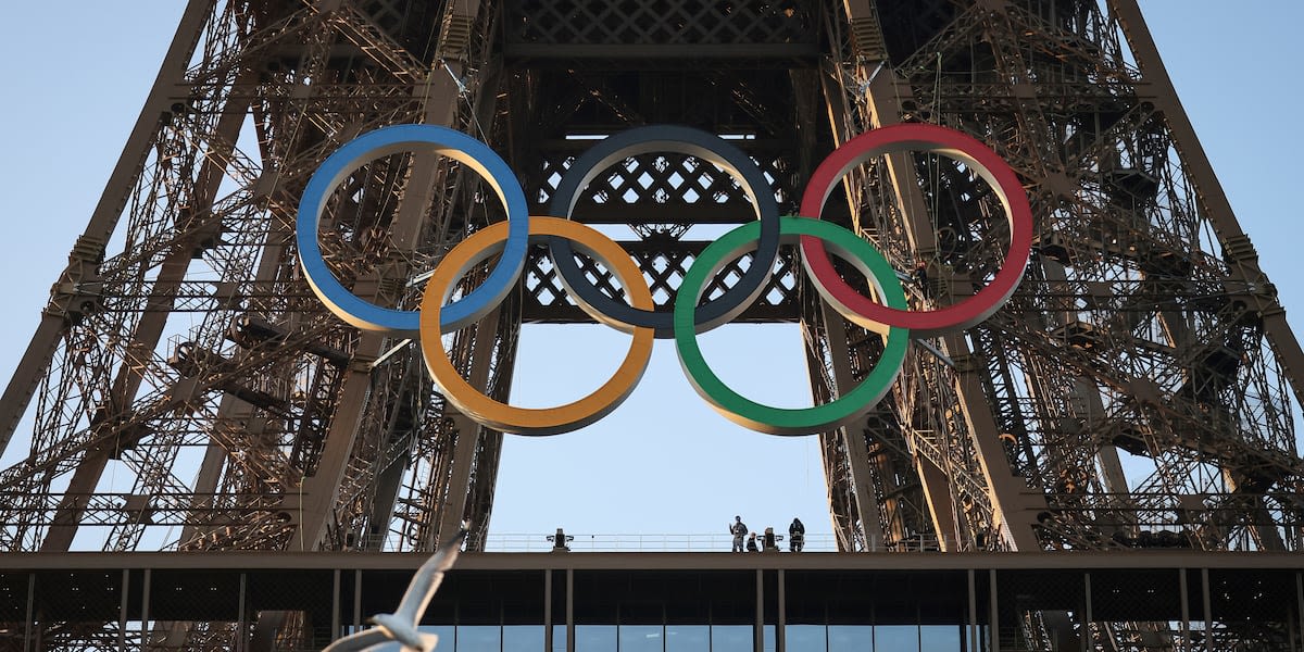 Paris Olympics organizers unveil a display of the five Olympic rings mounted on the Eiffel Tower