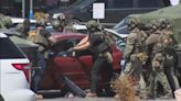 SWAT team pulls suspect out of car after standoff in grocery store parking lot