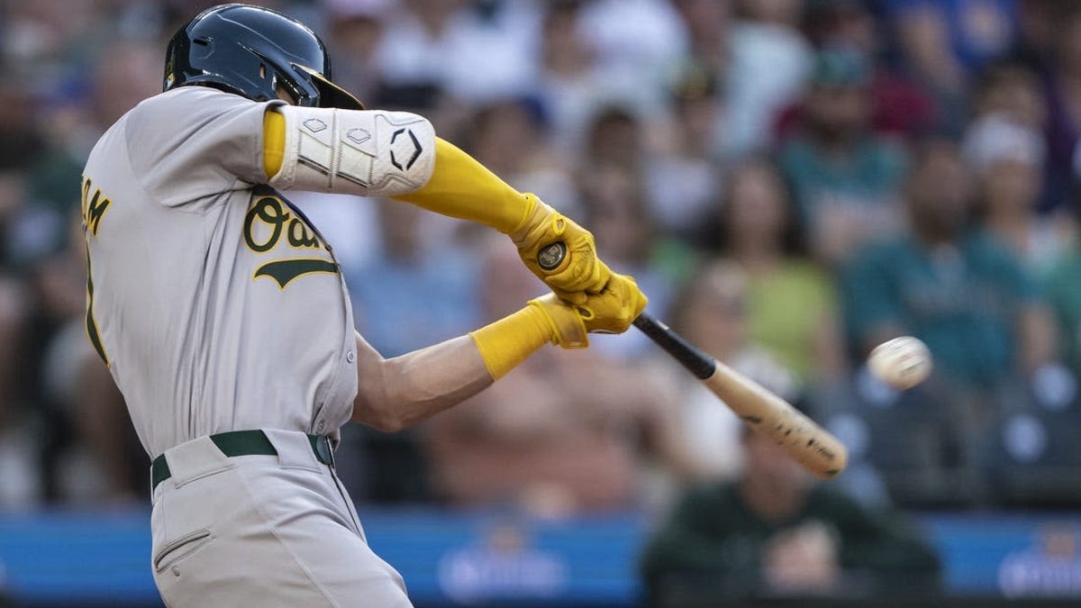 A's pull away late to pound Mariners