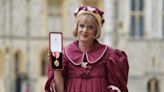 Grayson Perry accepts knighthood in burgundy taffeta dress in honour of the King