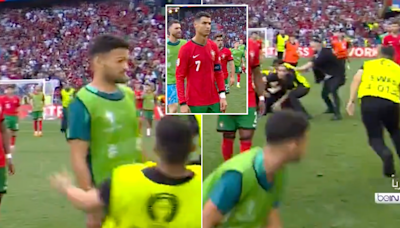 Security guard injures Portugal forward Goncalo Ramos after full-time whistle as pitch invaders cause mayhem