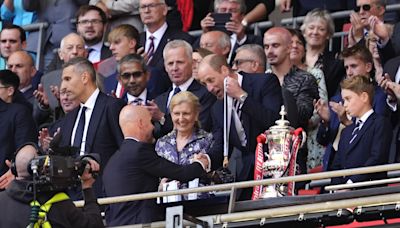 William and George present trophy to FA Cup winners Manchester United