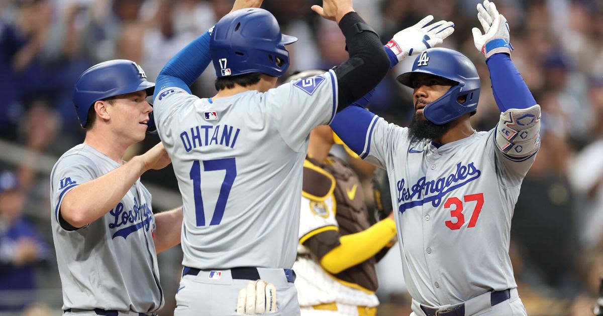 The Los Angeles Dodgers' Will Smith, left, and Shohei Ohtani congratulate Teoscar Hernandez after his grand slam during the sixth inning against the San Diego Padres...