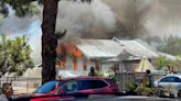 Flames burn through Carlsbad home, closing roads