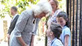 Queen Camilla looks summery as she visits a primary school