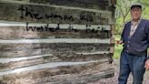 Volunteers clear graffiti from log cabin village school house