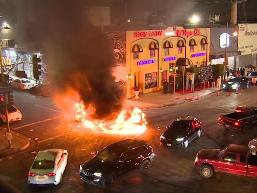 Street takeover in downtown L.A. leaves two cars in flames