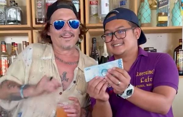 Johnny Depp Happily Samples a Drink Behind the Bar While Visiting a Restaurant in the Bahamas