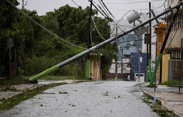 Ernesto strengthens into a hurricane as it knocks out power to half of Puerto Rico