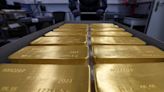 Gold plows to record high after Powell's remarks