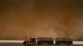 Videos and photos show a massive sandstorm chasing motorists and darkening the sky in northwestern China